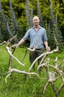 Painter Nick Williams with his arrangement of echium roots