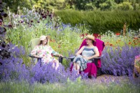 Women sitting in chairs chatting in the garden