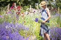 Woman carrying a bunch of Cornflowers