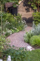 Terracotta brick curved running bond path; border plants include Rosa 'Queen of Sweden' and Salvia sylvestris 'Schneehugel' 