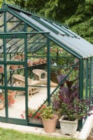 Greenhouse in a July garden