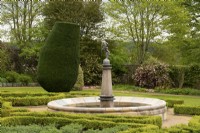 Taxus baccata topiary and Buxus hedge around a fountain in the Fountain Garden in the Crathes Castle Walled Garden.