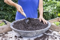 Woman mixing the compost and grit