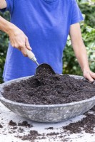 Woman mixing the compost and grit