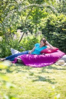 Woman relaxing on large bean bag