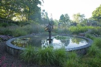 View of the circular Dragon Pond at Knoll Gardens, Dorset