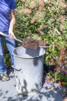 Woman placing compost in the bin