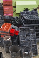 Assorted plastic trays and containers for starting seedlings.