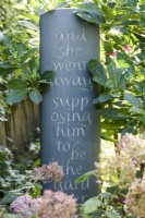 Slate with inscribed lettering in a summer garden