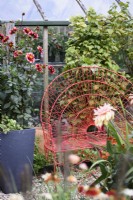 Red wire seat in a September garden