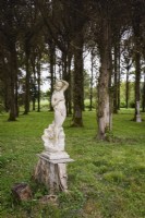 Statue of Venus amongst trees in a September garden