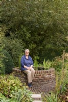 Woman sitting in her garden in September