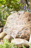 Rock water feature with pebbles around base