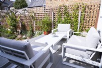 Table and chairs on raised patio overlooking garden