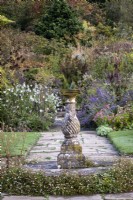 Sundial set in paved path at Gravetye Manor, Sussex