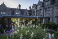 The gardens at Gravetye Manor, with Lupinus 'Noble Maiden' in small bed outside the restaurant