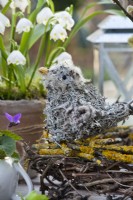 A bird made of lichens and clematis seedheads in the nest.
