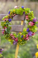 Wreath made of spring flowers including Muscari, Hacquetia epipactis, Corydalis and Chaenomeles.