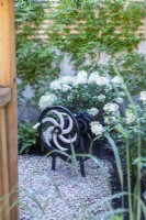 Decorative metal crank in garden corner