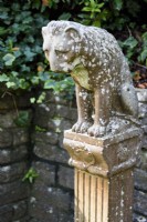 Sculpture of a lion on a plinth in the Palm Court at Compton Acres, Dorset in November