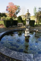 Circular pond in the kitchen garden at Athelhampton, Dorset in November