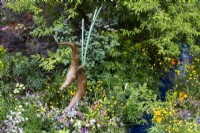 Sculpture of otters by Simon Gudgeon surrounded by wildflife friendly planting on the RSPCA Garden designed by Martyn Wilson - RHS Chelsea Flower Show
