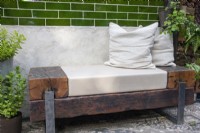 Bench made from reclaimed railway sleepers on The St George 'Alright Here balcony garden designed by Emma Tipping - RHS Chelsea Flower Show 2023
