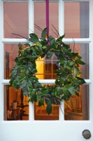 Portugese laurel and dogwood Christmas wreath hanging on house door
