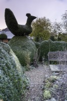 Topiary yew bird perched on a hedge at Balmoral Cottage, Kent in December