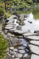 Stepping stones arranged at the lakes edge known as Iso-watari