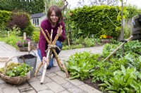 Woman spreading sticks out to create stand