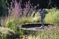 Cherub in a circular pond in the herb garden at Parham House, West Sussex in September