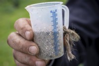 Carefully measured fertiliser in a graduated beaker