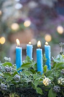Blue candles in metal basket with Yew sprigs and Ivy