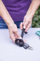 Woman tying the string in a knot near the brace clip