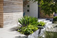 Raised bed and water feature outside modern home