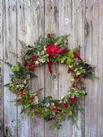 Winter Christmas wreath on bleached wooden door