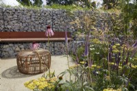 Designers: Caroline and Peter Clayton. Seating area with Echinacea 'White Swan', Achillea millefolium 'Terracotta', Veronicastrum and Echinacea pallida in wildlife-friendly dry garden. 
