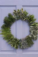 Worked examples of possible evergreens for wreaths identified by handwritten labels: holly, bay, pittosporum, rosemary, rosemary, lavender, spindle, yew and cypress.