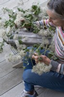 Long lengths of freshly picked, pliable old man's beard, gathered from the hedgerows, are woven round a florists' wire frame before being hung in a dry, cool place to dry for 3 weeks.