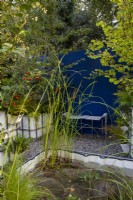 Repurposed upcycled industrial IBC -  intermediate bulk containers - to create a modern contemporary multi layered woodland planting - a pond with aquatic plants of Typha gracilis - Cat's Tail Bulrush, Aponogeton distachyos, Cyperus longus and Carex riparia