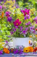 Summer bouquet in enamel pot with cosmos, sweet peas, fennel, bergamot and snapdragon.