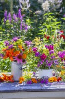 Summer flower arrangement with cosmos, coneflowers, sweet peas, fennel, bergamot, pot marigold and hemerocallis.