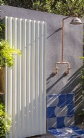 An outdoor shower - rendered grey wall with powder coated painted corrugated steel panel - wall tiles 