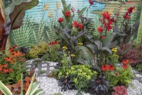 'Hot' perennials in mixed border in the 'In Memento' garden at BBC Gardener's World Live 2021