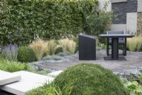 Seating area in 'Shades of Grey' at BBC Gardener's World Live 2021 - urban contemporary garden using different grey hard landscaping materials