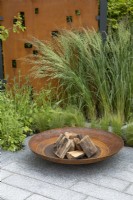 Fire pit and metal screen in 'High Line' garden at BBC Gardeners World Live 2019, June