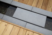 Formal rill with stepping stone to link two areas of decking 