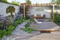Seating area in the 'Wetland Plants - The idea of Wilderness' garden at BBC Gardener's World Live 2017, June