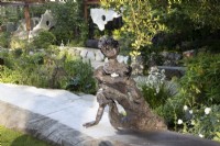 Sculptor Andrew Litten bronze Sculpture - Listening overlooks the modern contemporary garden designed by Darren Hawkes 